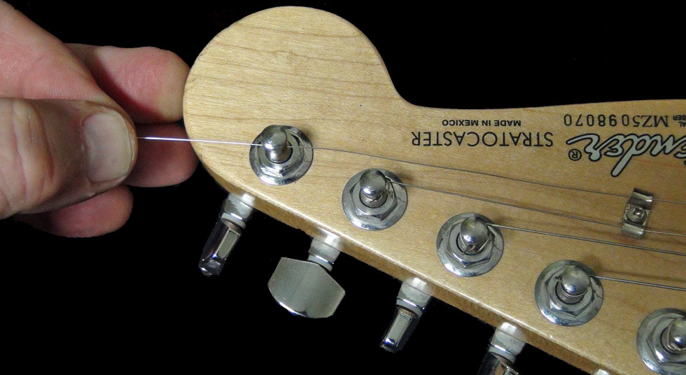 Pass the string through the hole in the tuning peg