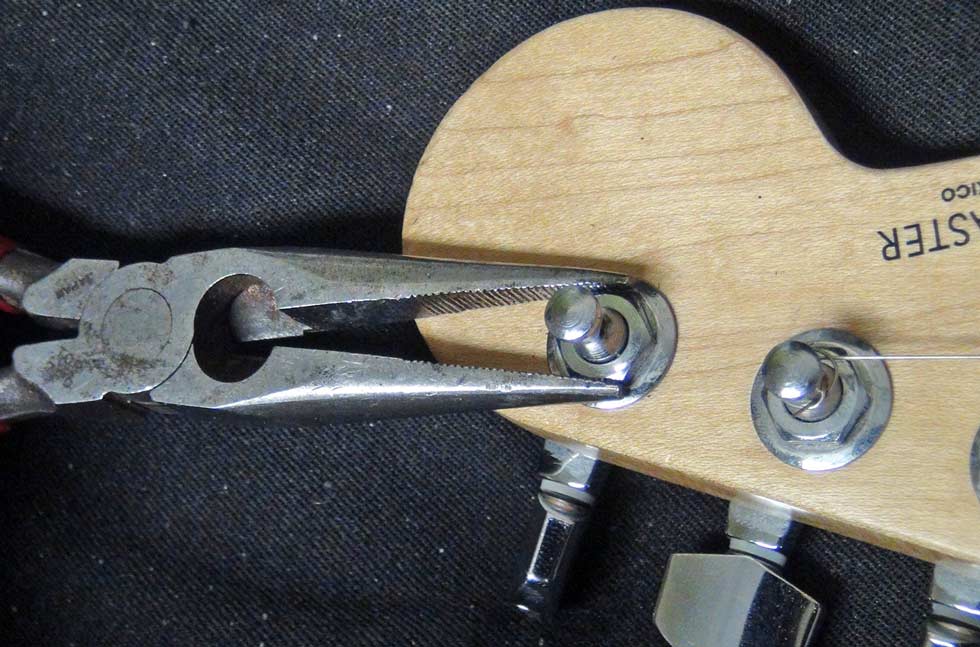 Tighten the screw(s) or nut that hold the tuning peg assembly attached to your guitar